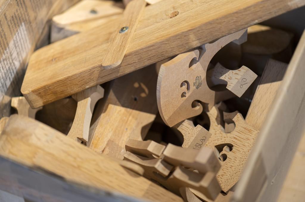 An assortment of carved wooden dissembled violin components
