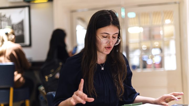 A student sits studying sheet music