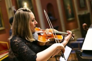 A string student rehearsing, reading sheet music