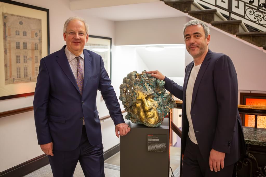Jonathan Freeman-Attwood and Alexander Polzin pose for camera next to a sculpture of Bach