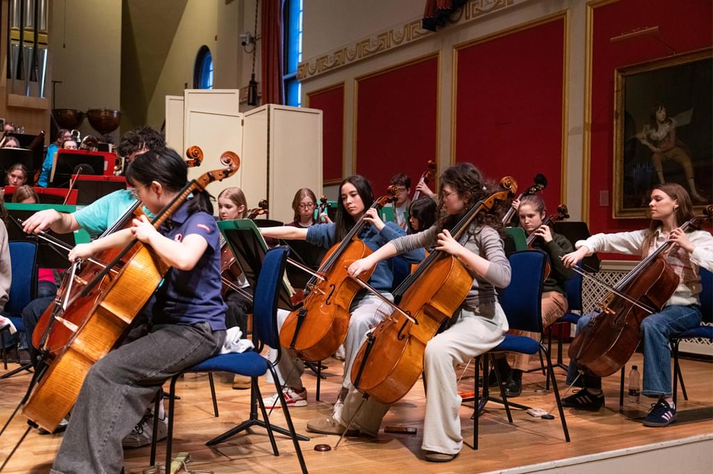 An image of the Junior Academy Symphony Orchestra in rehearsal in the Duke's Hall