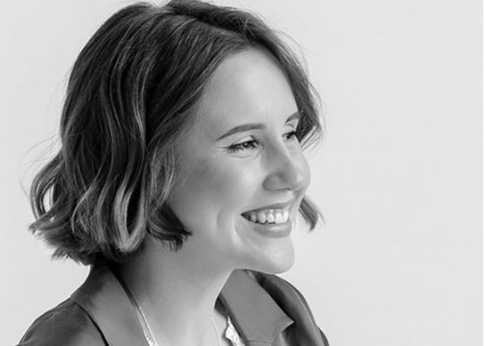 Katya Grabova smiling in black and white