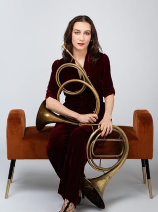 Anneke Scott holding a horn