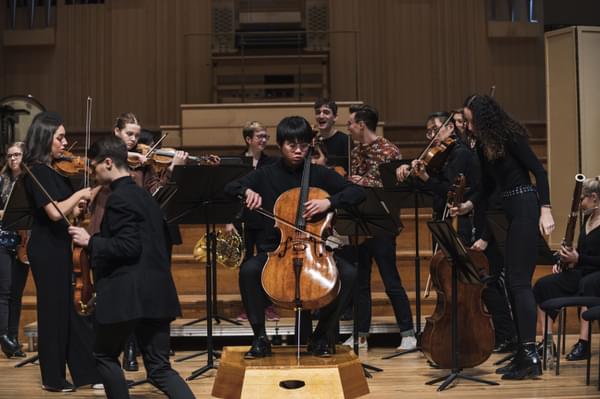 A string ensemble play intensely in concert