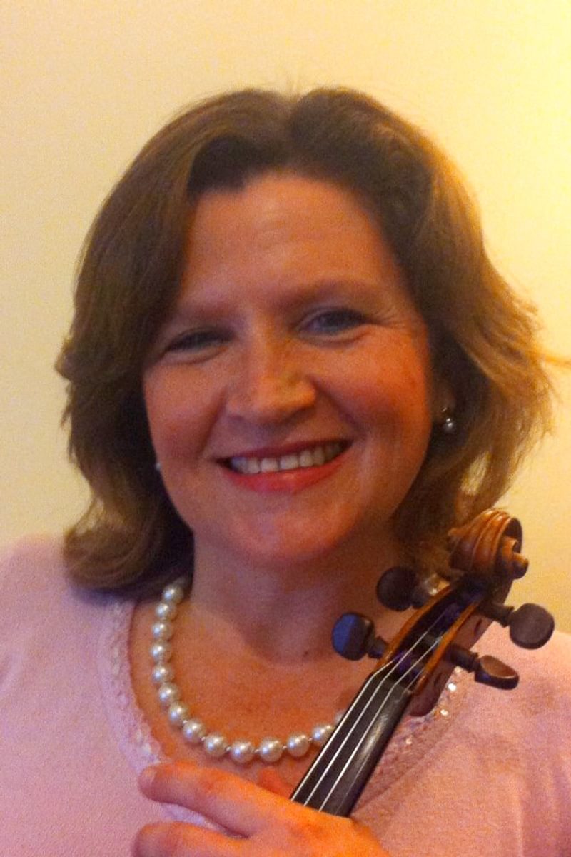 Erica Grajner poses for photo, holding a violin