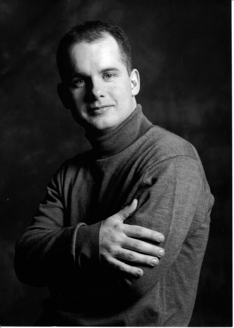 Black and white image of Graham Caskie posing for headshot