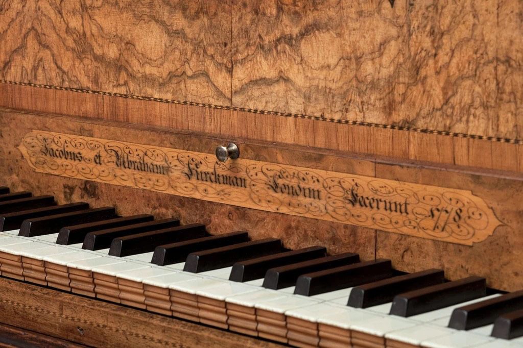 A harpsichord with an ornate wooden lid