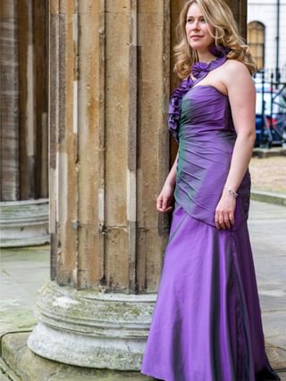 Jocelyn Freeman standing by a building column