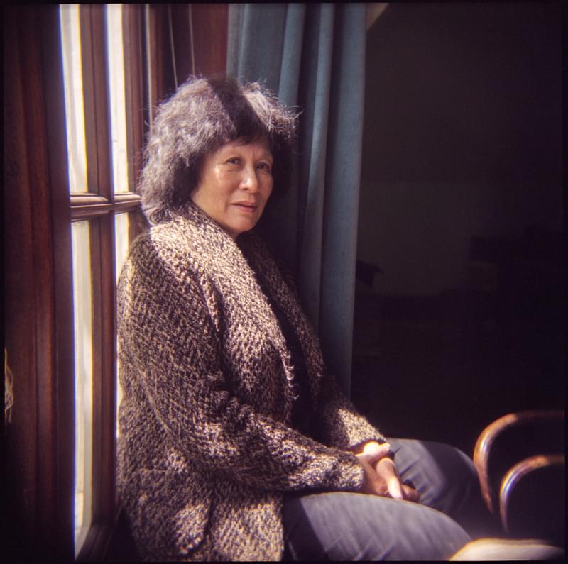 Patsy Toh poses for camera, sat near a sun-lit window