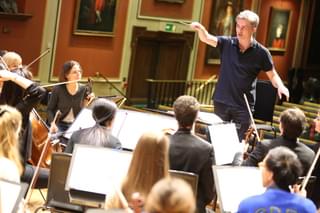 Ed Gardner conducts at a rehearsal with students