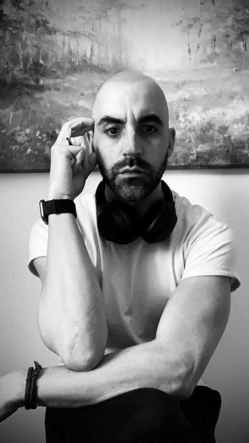Rubens Askenar poses for camera, with hand held against the side of head
