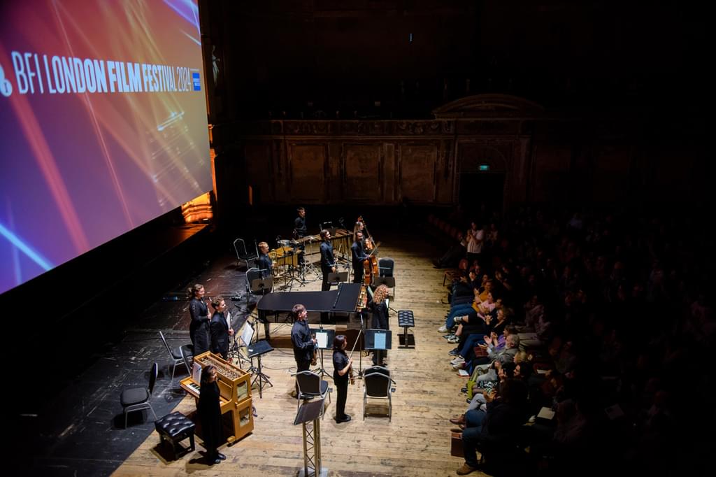 Academy musicians on the stage of Alexandra Palace's Theatre, receiving applause