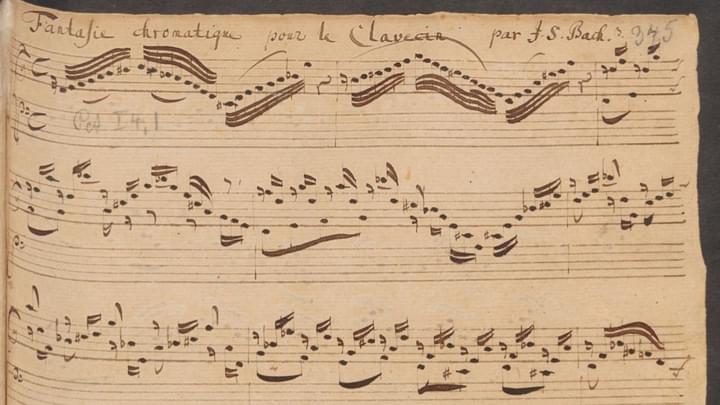 An extract of an old music manuscript - dark brown hand written notes on brown aged paper