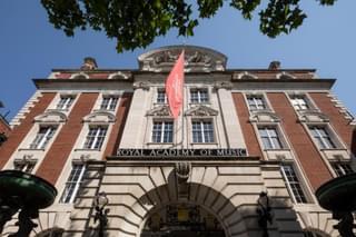 The front of the Academy building with the flag flying