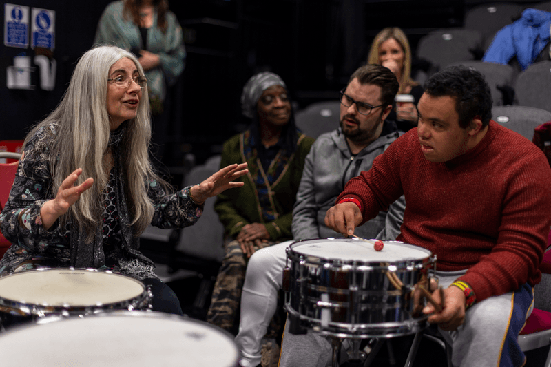 Image of Dame Evelyn Glennie working with a member of the City Lit Percussion Orchestra