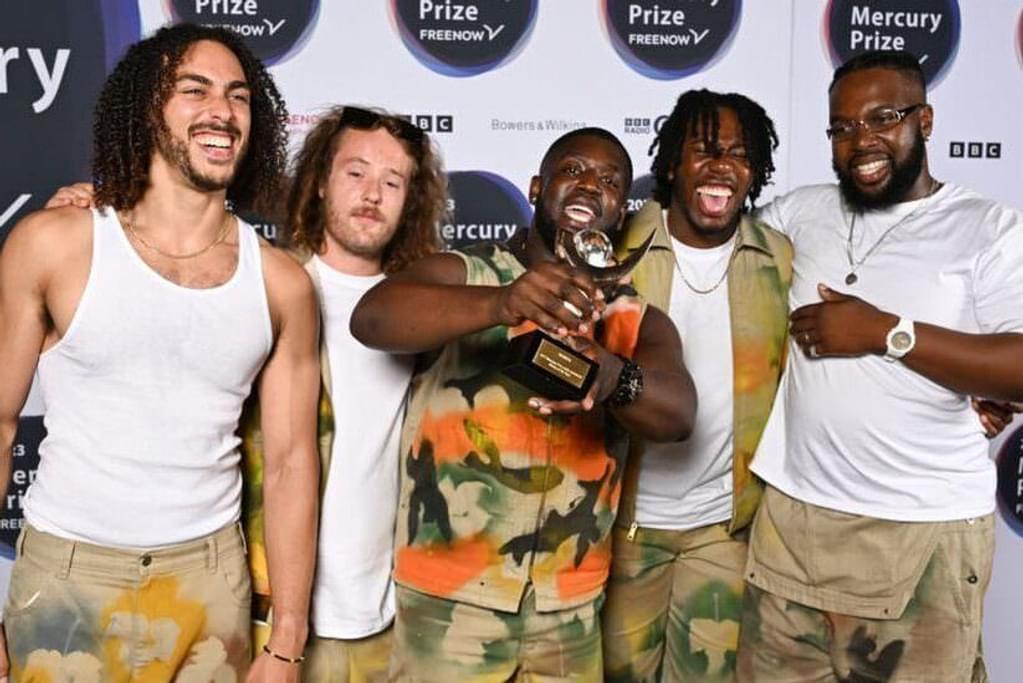 Ezra Collective pose for camera shortly after winning the Mercury Music Prize, looking very happy