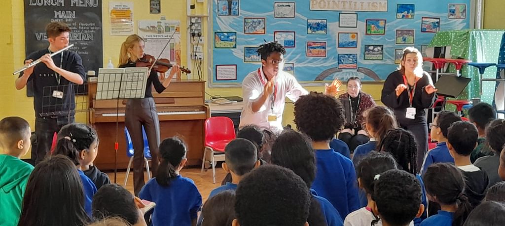 Academy postrgraduate students lead a workshop at the front of a Primary School class at Rhyl Community Primary School