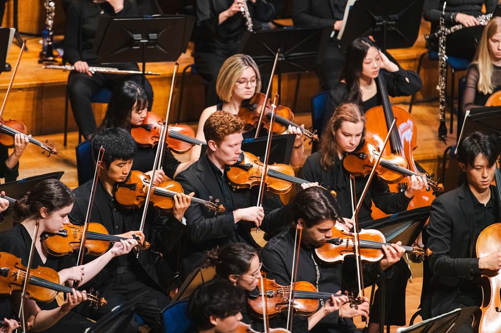 An image of the strings section of the Academy Symphony Orchestra performing