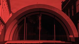 Decorative red image of the front window of a concert hall