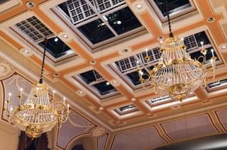 Chandeliers hang from a ceiling