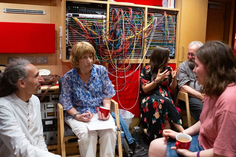 Musicians in discussion in a recording studio
