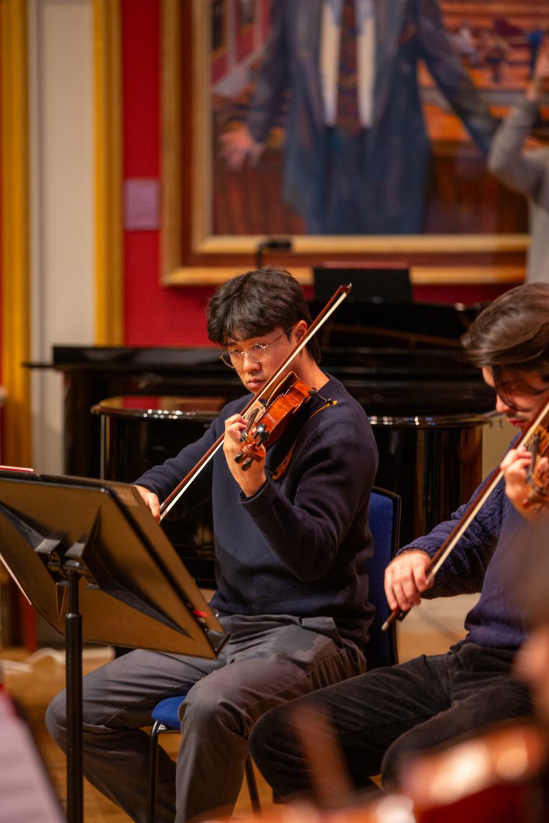 An Academy strings student rehearses in the Dukes Hall with the LPO
