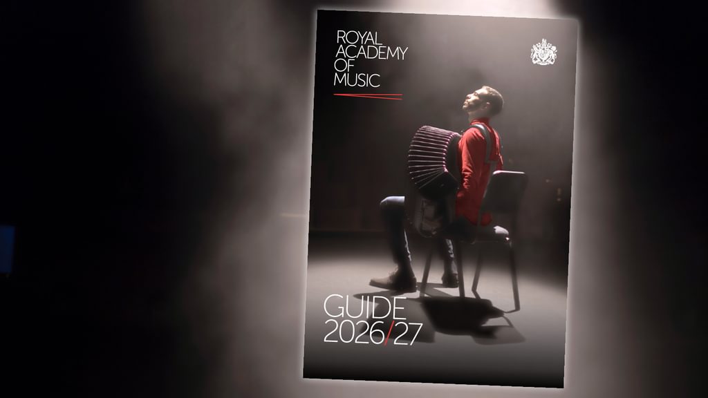 An inset of the front page of a printed guide, with an accordionist draped in a spotlight