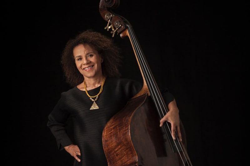 Chi-chi Nwanoku holding her double bass and smiling