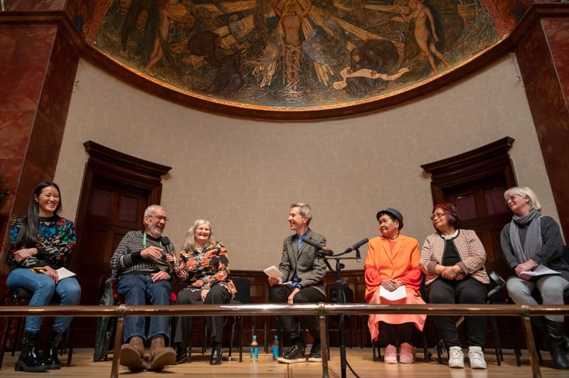 A group of people in discussion on stage