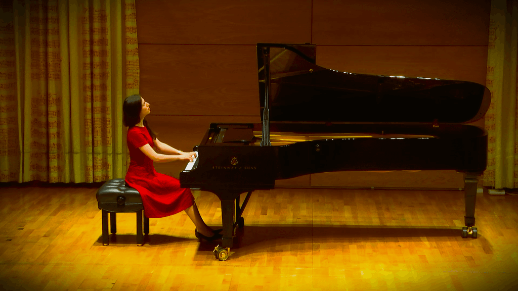 Inbar Rothschild at a piano in concert