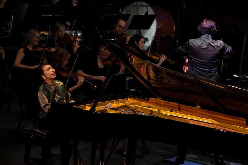 Junyan Chen performing on a grand piano in the Final of the Leeds International Piano Competition with the Liverpool Philharmonic Orchestra