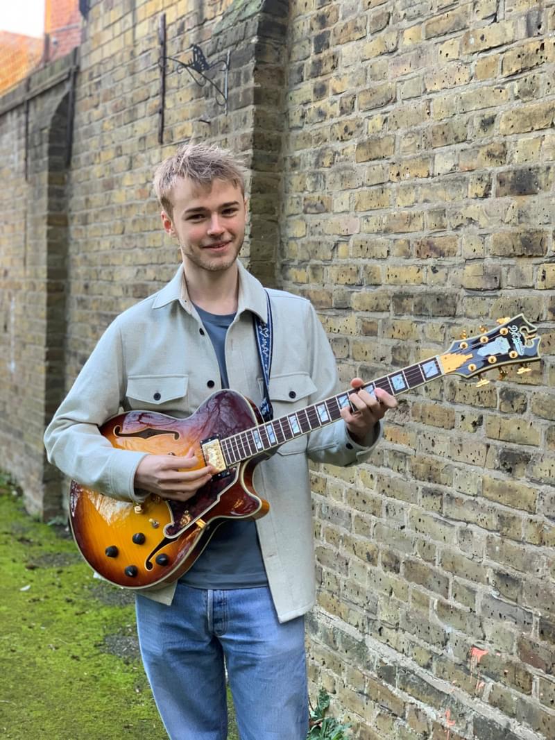 Stan Brunt holding a guitar