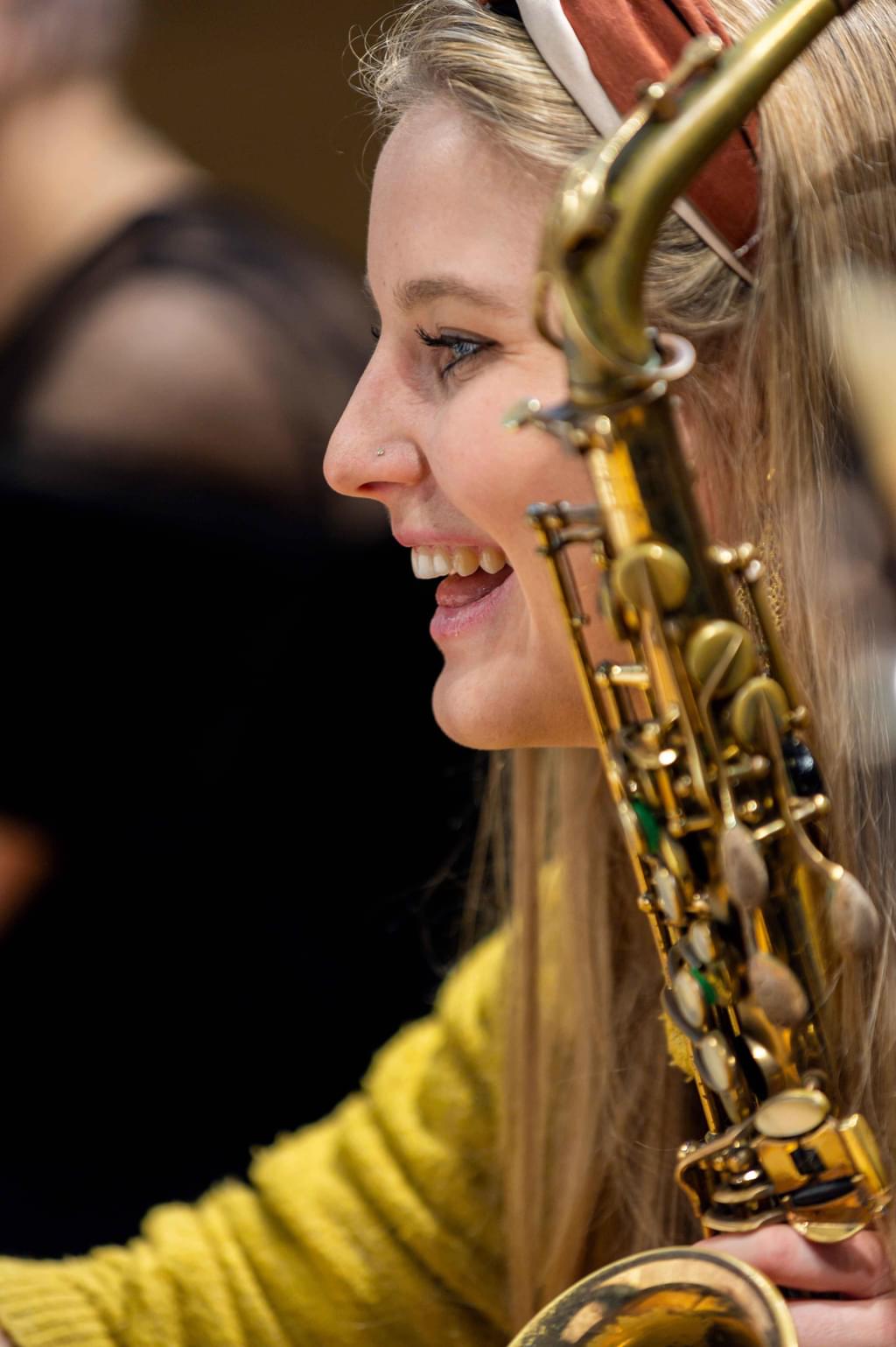 A student smiles in the middle of a rehearsal
