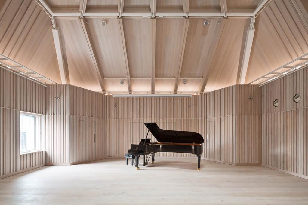 A cleared Angela Burgess Recital Hall with a grand piano at the back