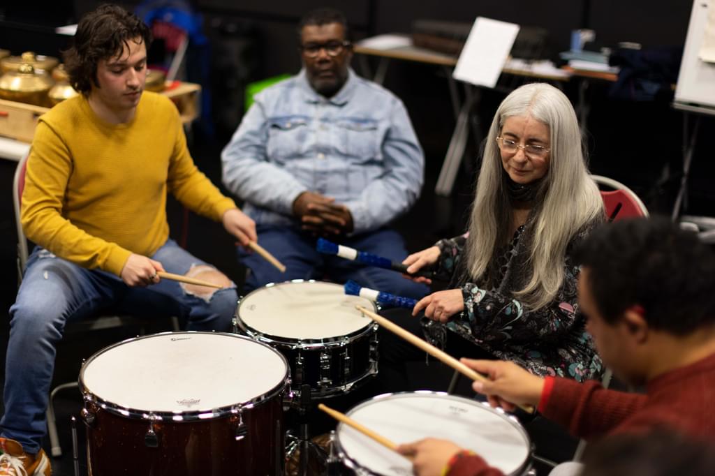 Image of Academy student Zach Mitchell and Dame Evelyn Glennie working with members of the City Lit Percussion Orchestra