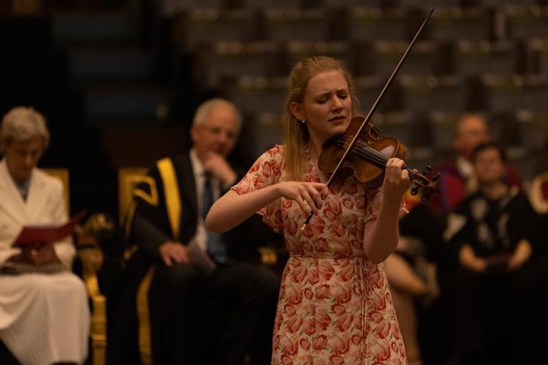 A violinist performs intensely