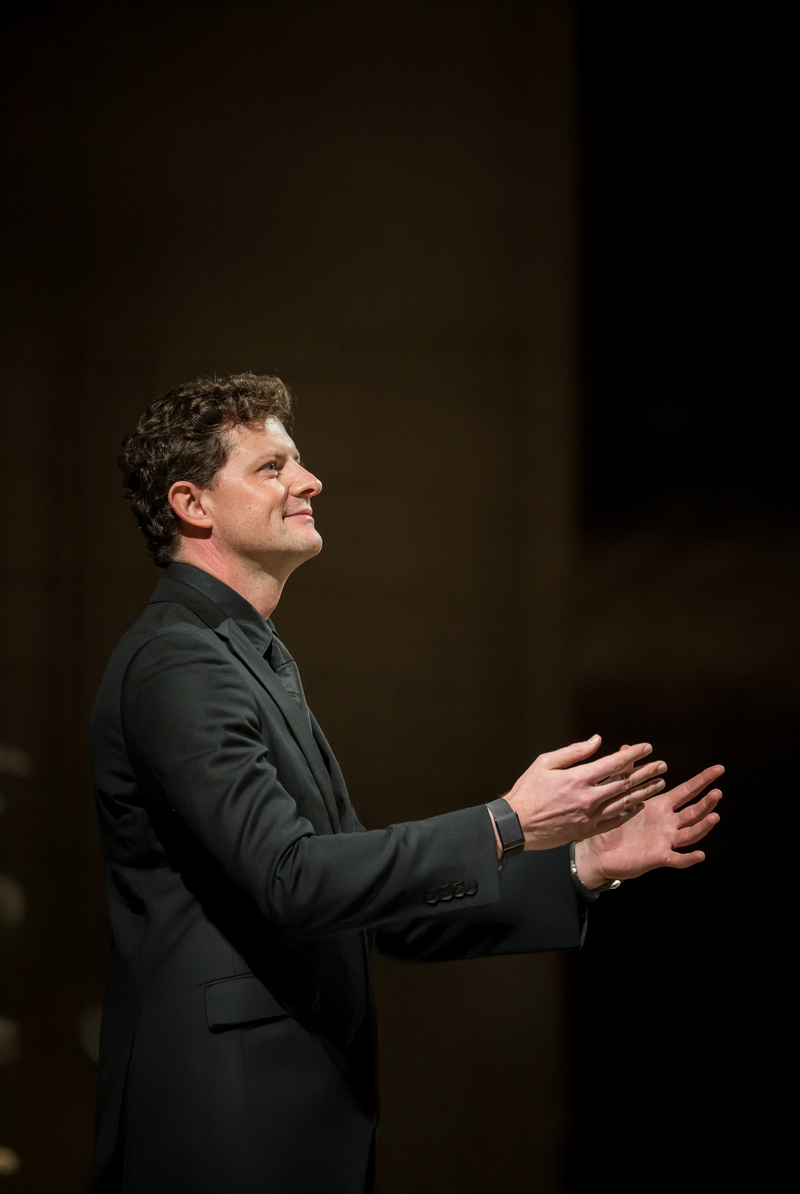 Close-up headshot of Nicholas Chalmers looking into camera against a pale background